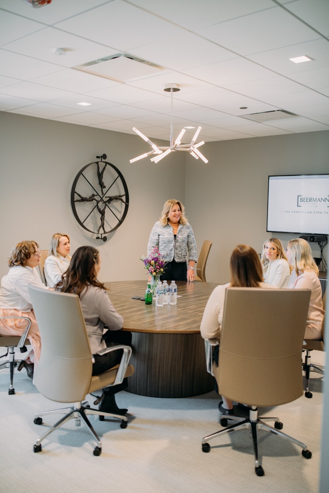 Beth McCormack with members of her team at a conference table